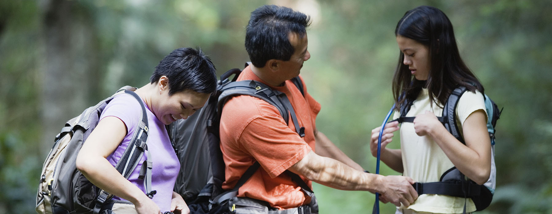parents preparing for hike with daughter